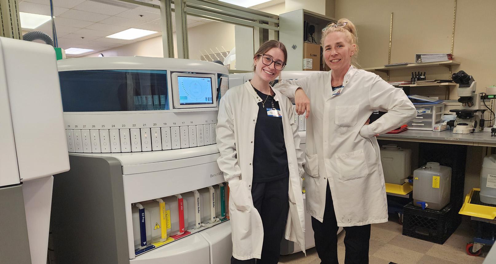 2 doctors smiling and standing in a laboratory
