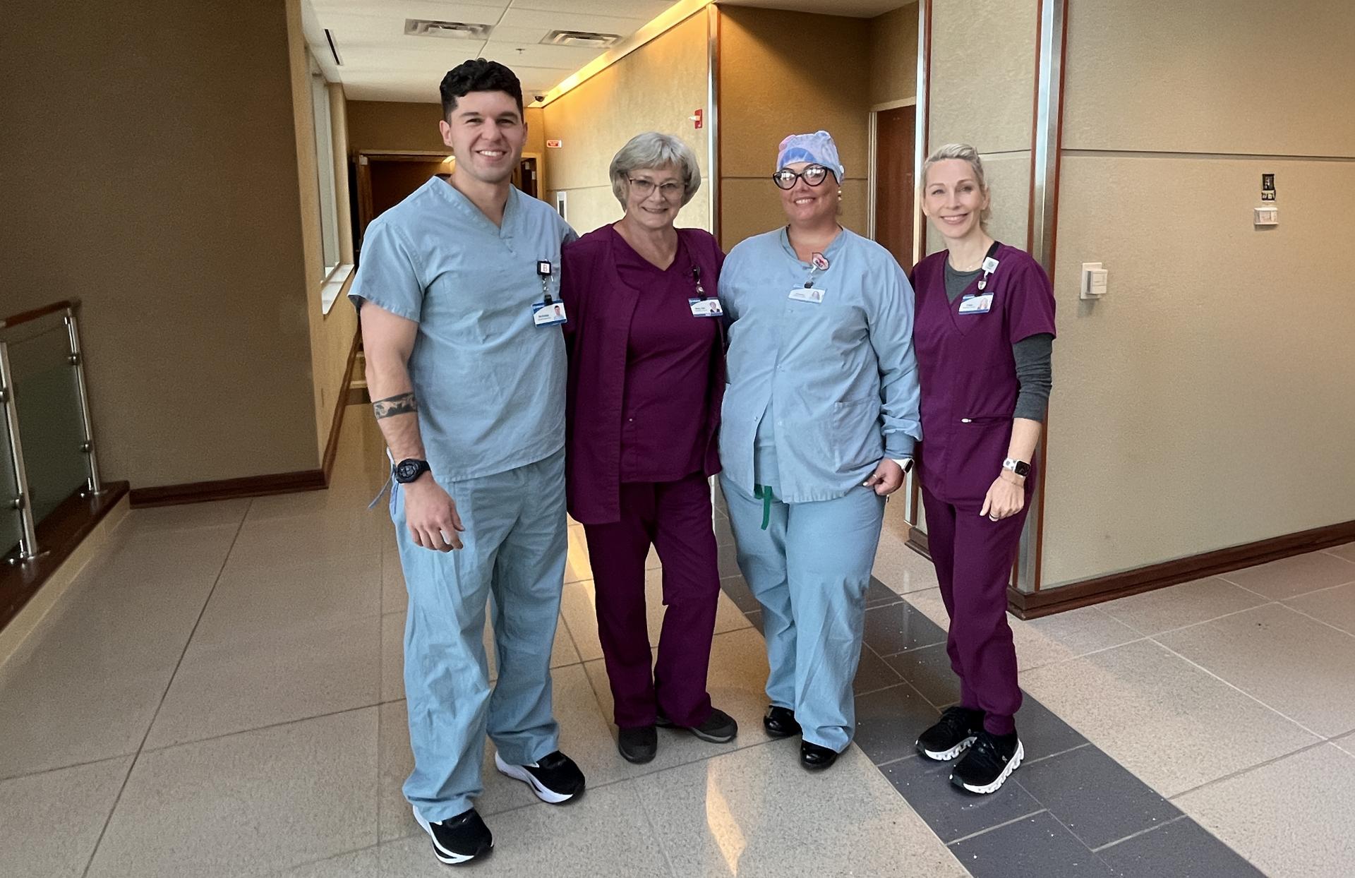 Two Allied Health CT Scan employees with two doctors smiling.
